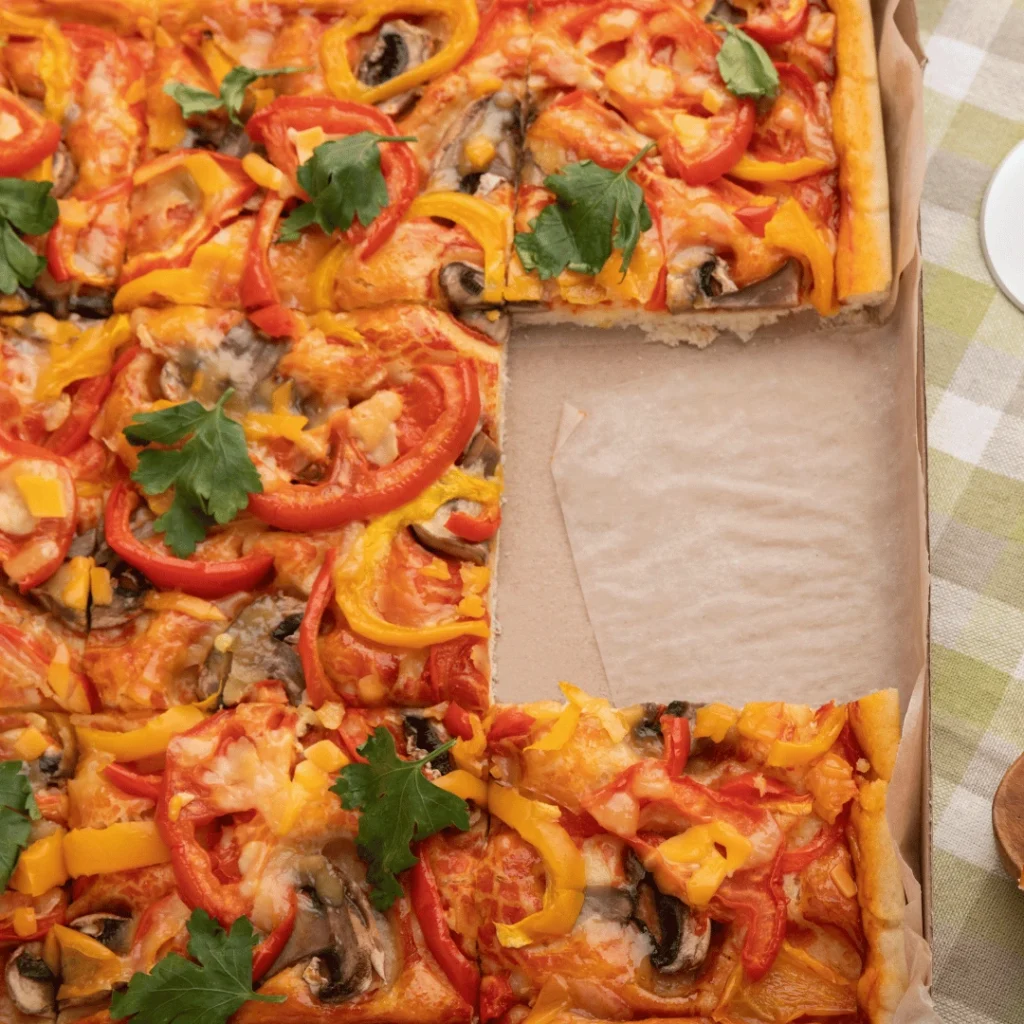Freshly baked square pizza with crispy crust and melted cheese, sliced and ready to serve.