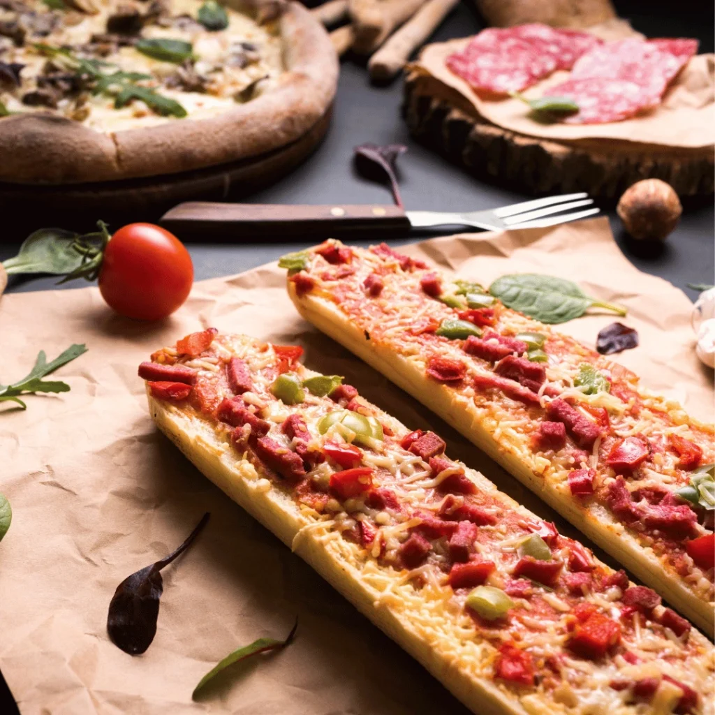 Cheesy pizza sticks with golden crust, served with a side of marinara dipping sauce.