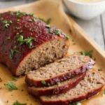 Delicious smoked meatloaf recipe served with a side of vegetables.